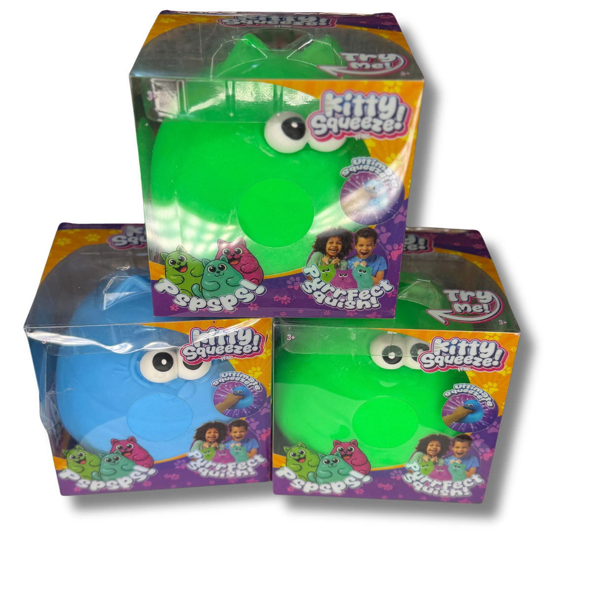 Three boxed 'Kitty Squeezes!' surface tension toys stacked in a pyramid on a white background. The top box contains a green toy, and the two lower boxes contain blue and green versions respectively, all in clear plastic packaging with colorful orange, purple, and yellow labels.