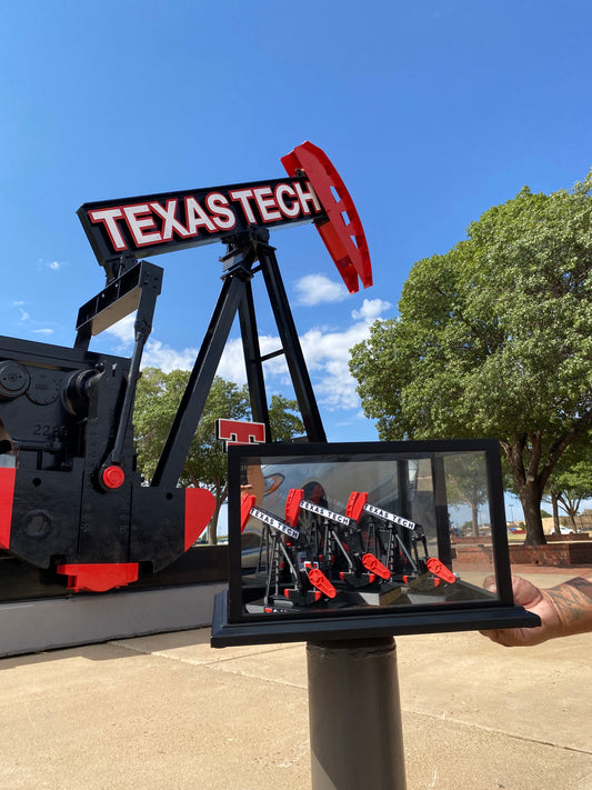 Pump Jack with 'Texas Tech' branding against a blue sky
