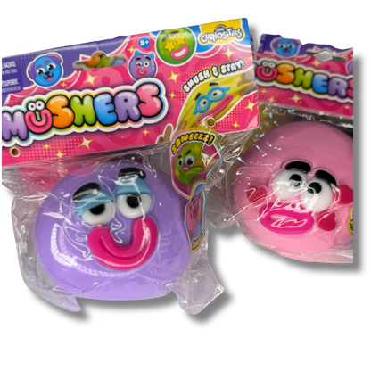 Two packaged smushers toy figures from Chosha's, one purple and one pink, in clear plastic wrapping with colorful branded cardboard headers.