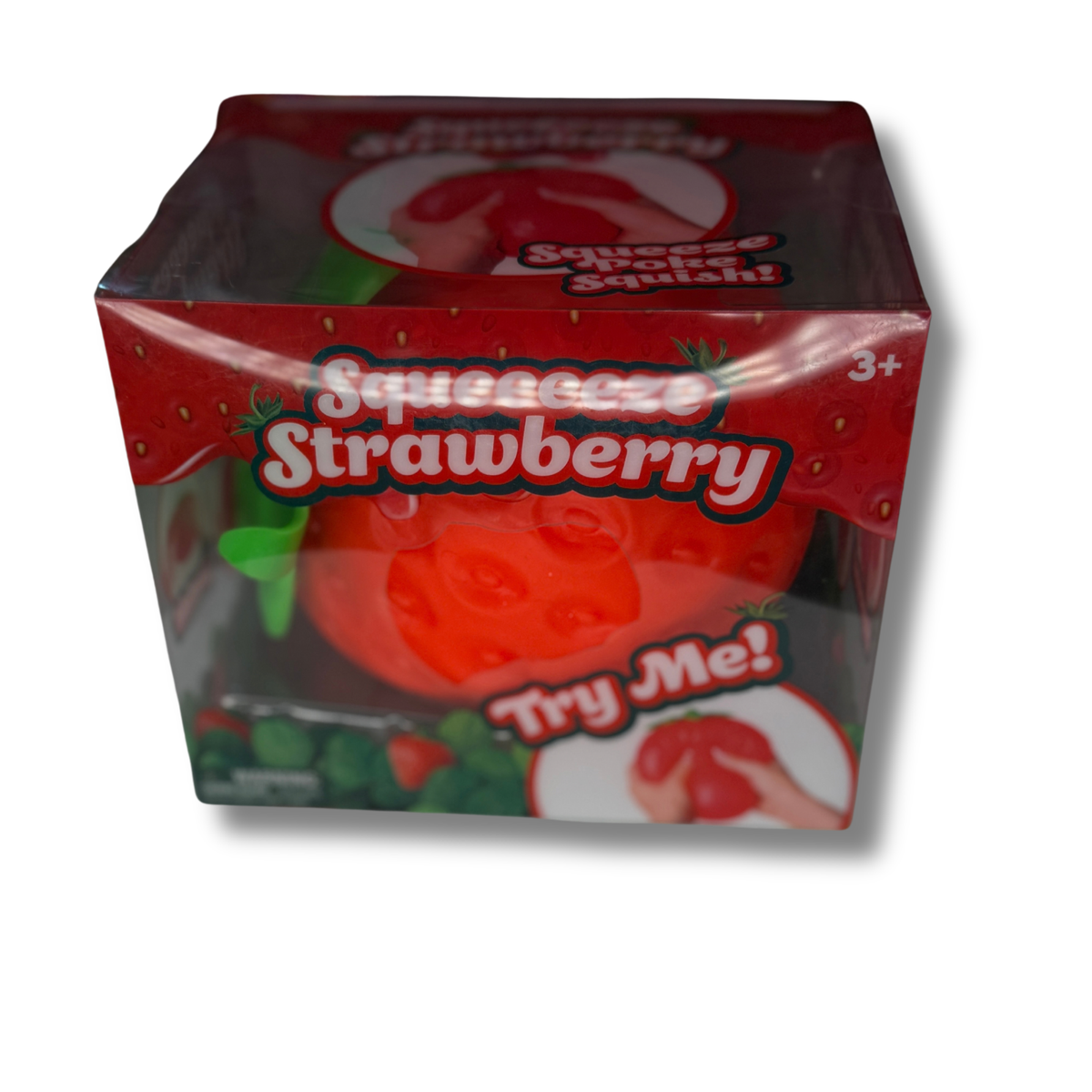 A box of Squeezze Strawberry squishy toy, featuring a red strawberry-themed packaging with a clear window showing the red squishy toy inside, on a white background.