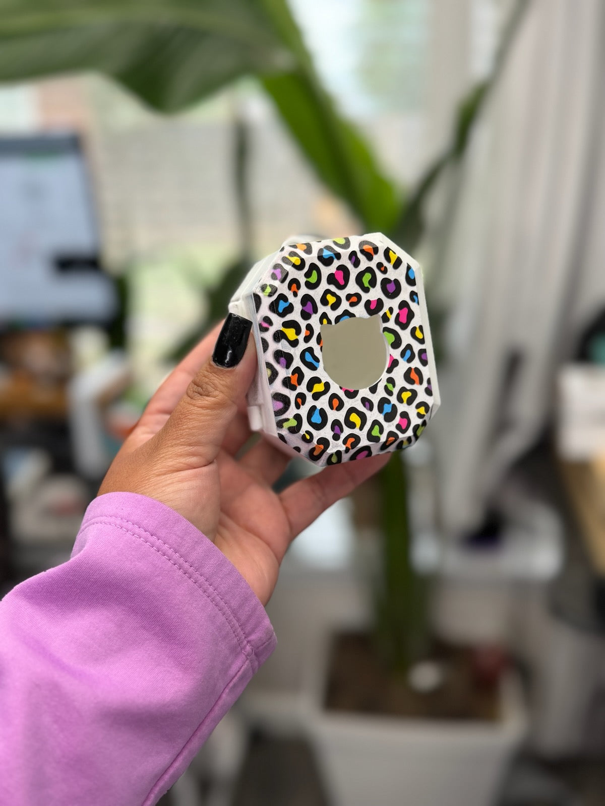 Back of rainbow leopard print case with a cat-shaped opening